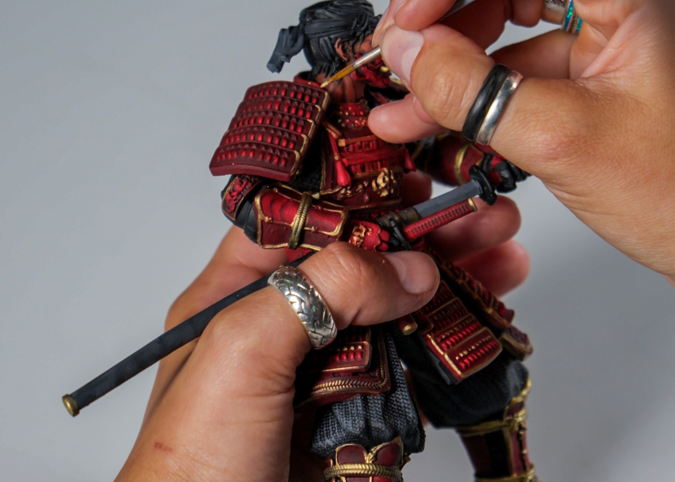 An artist hand-paints a samurai figure for a custom PC