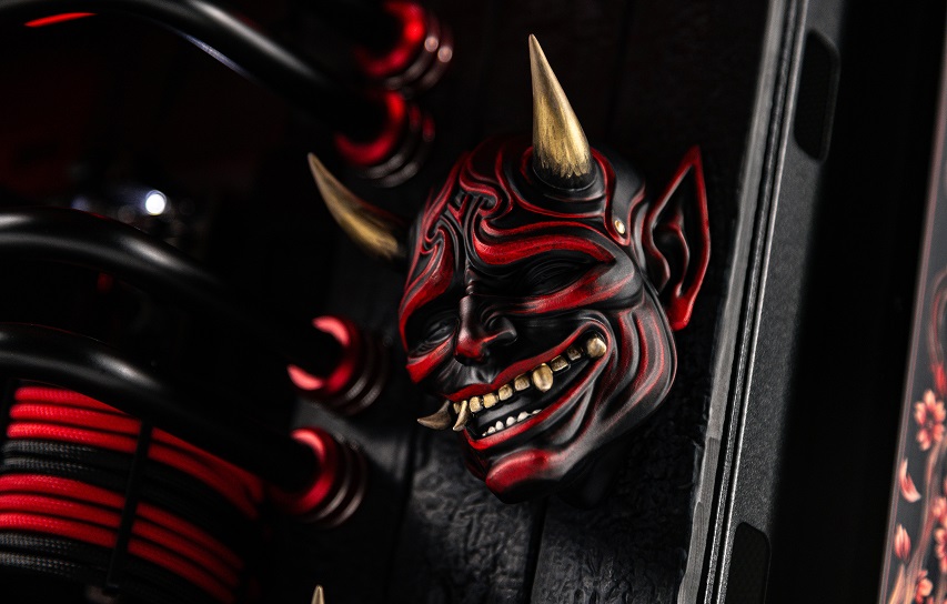 Sculptural oni masks on the computer panel
