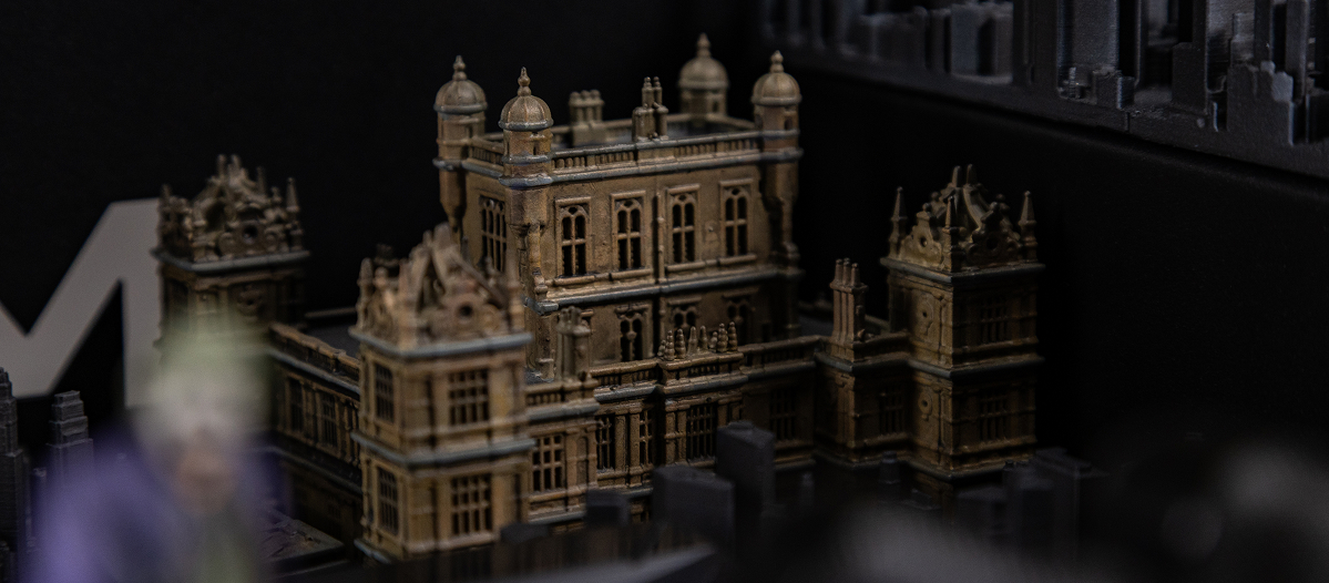 Miniature Gotham buildings beneath the glass desktop