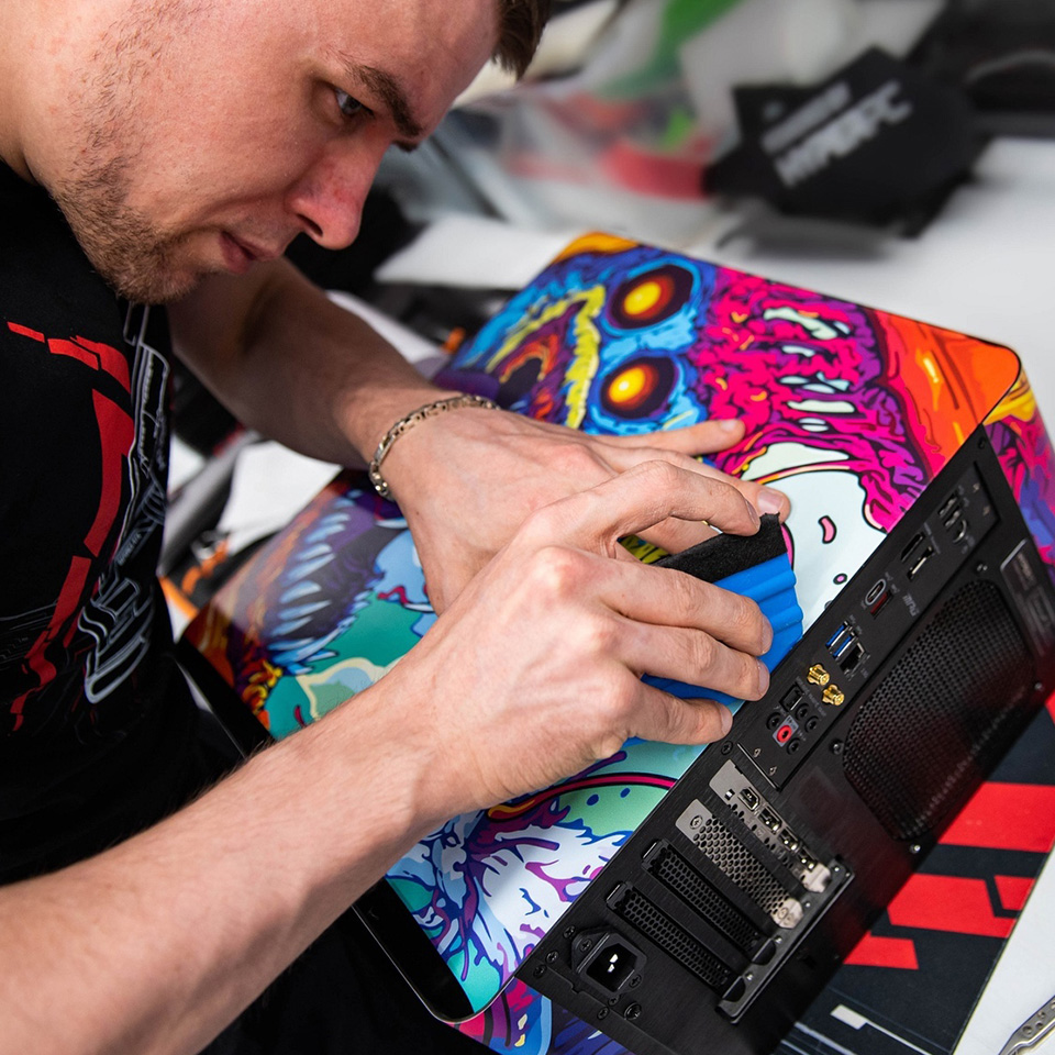 Craftsman applying decorative coating to a computer case